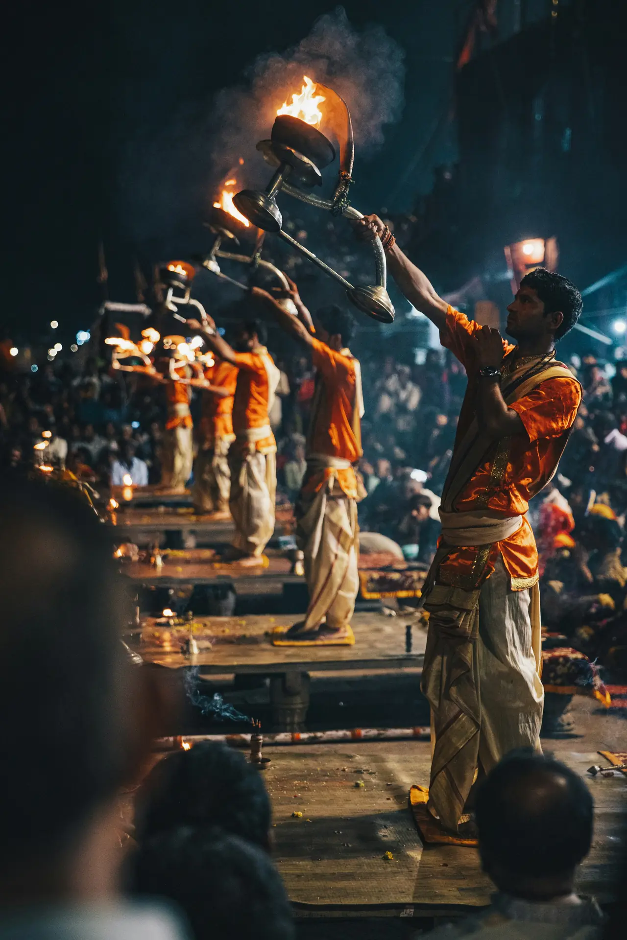 Priests performing the Ganga Aarti with fire lamps in Varanasi